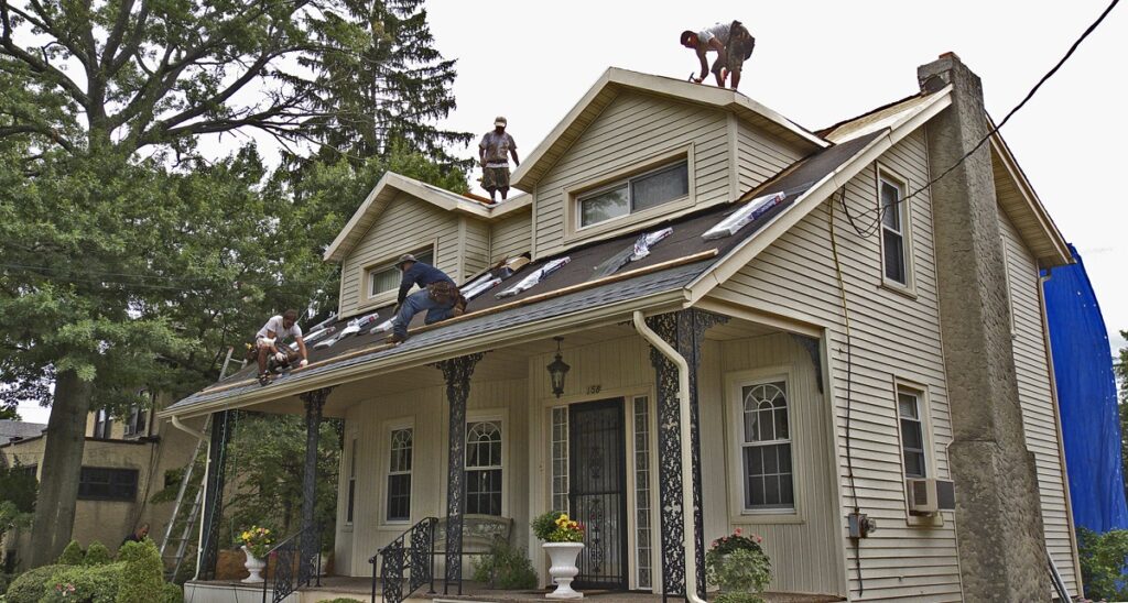 roofing contractor working on home