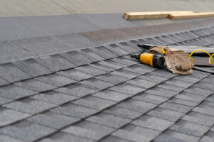 nail gun lying on asphalt shingle